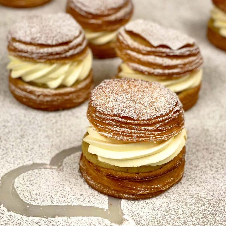 Semla bun - a tender, fluffy cardamom bun filled with cardamom and almond paste and covered in whipped cream