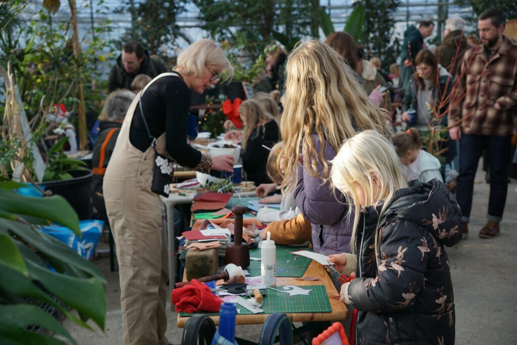 Children and an adult participating in a crafts workshop