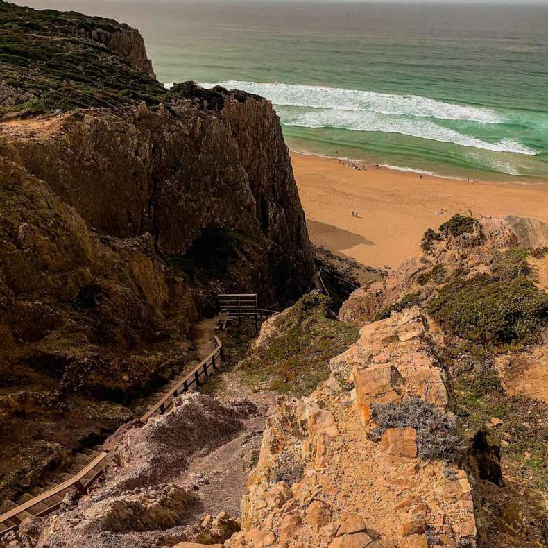 Visit Praia da Adraga beach to enjoy the ocean breeze and the wild scenery