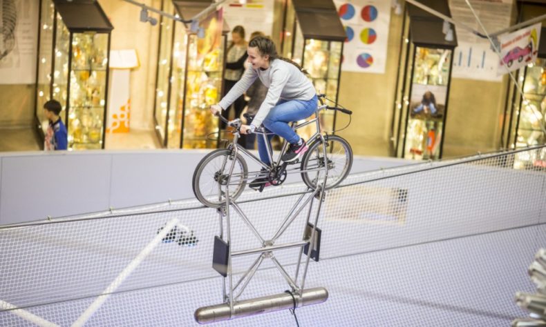 Ride a bike high above the ground in the Hall of Science in the AHHAA Science Centre