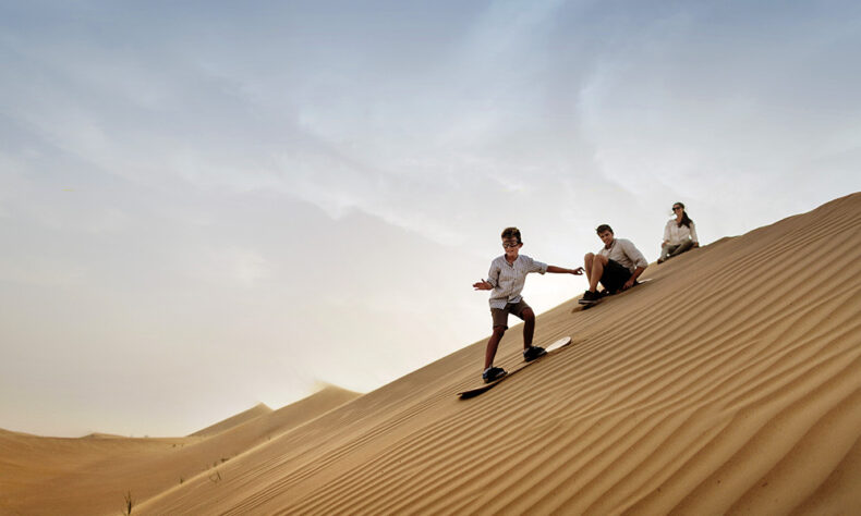 While you are in Dubai, try out sandboarding in the desert