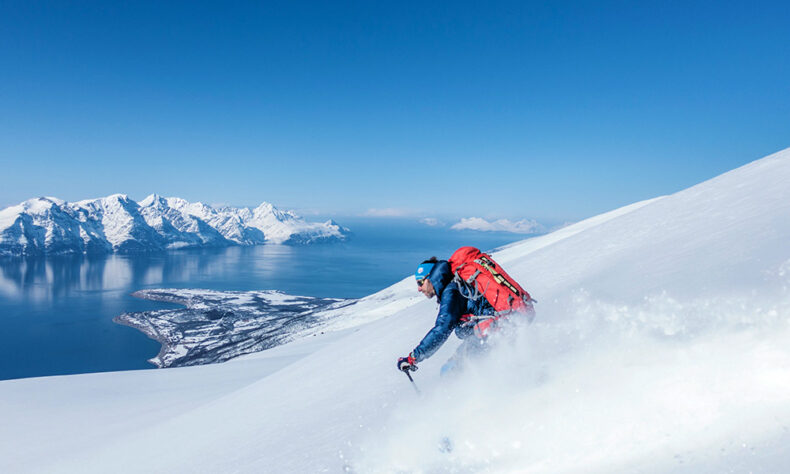 Man skiing in Norway with a view of fjords