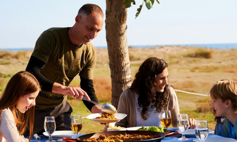 Family eating Valencia traditional dish - paella