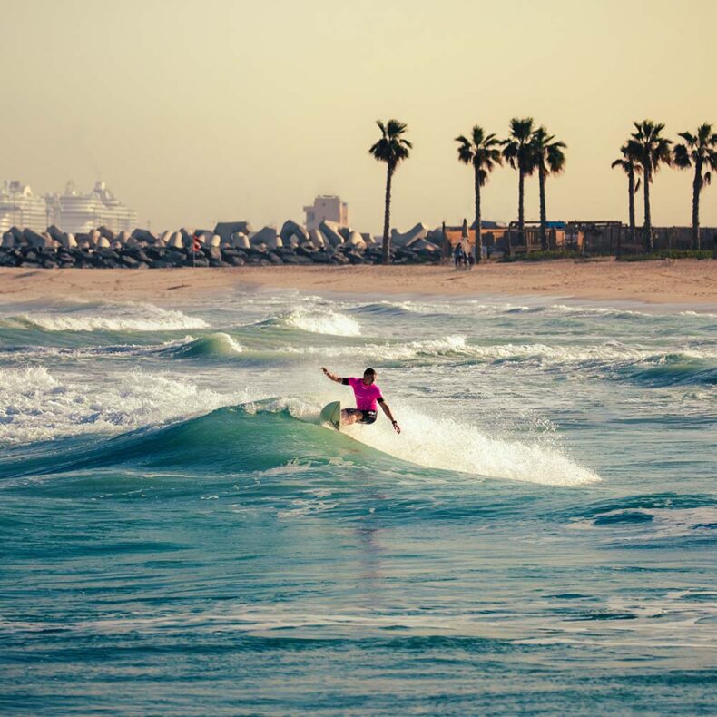 A surfer enjoying waves in Jumeirah Beach in Dubai