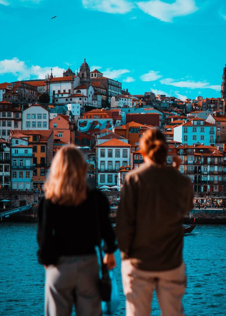 The couple looking at the part of Porto with the red rooftops of old houses