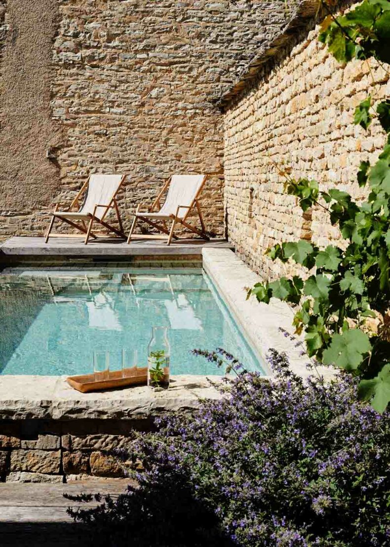 Relax by the pool that is surrounded by the garden at the boutique hotel La Maison de Pommard