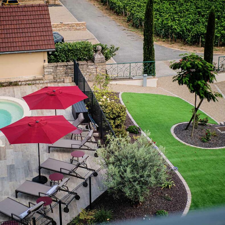 Relax by the pool, which is surrounded by vineyards