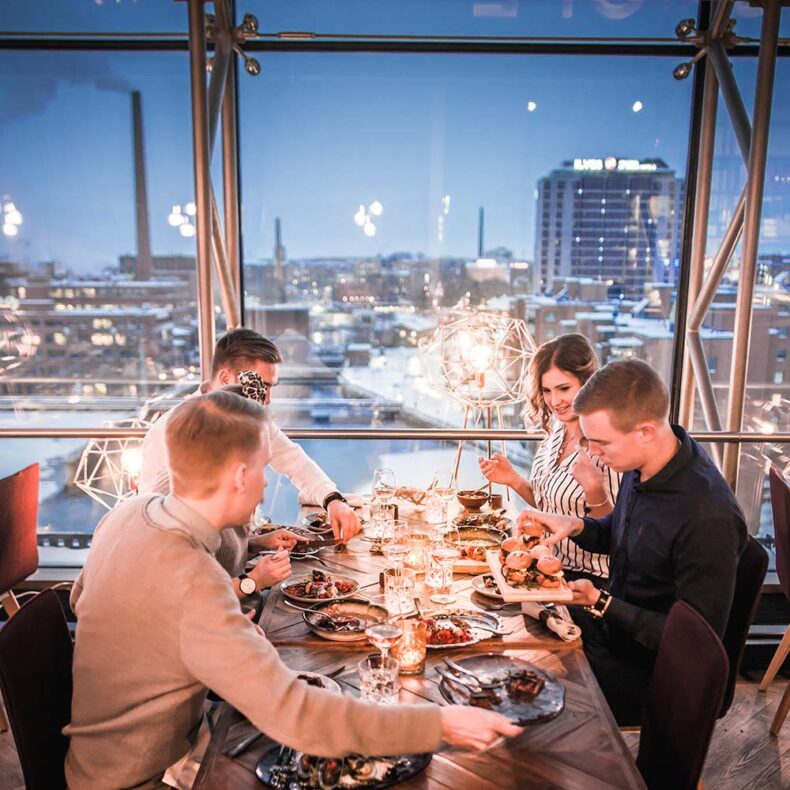 Group of people having dinner at restaurant Periscope