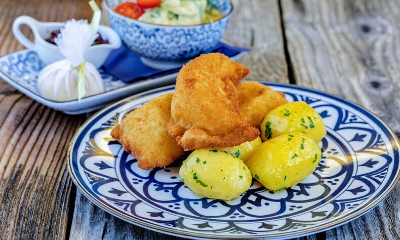 Austrian local cuisine - Wiener Schnitzel, breaded and fried veal cutlet
