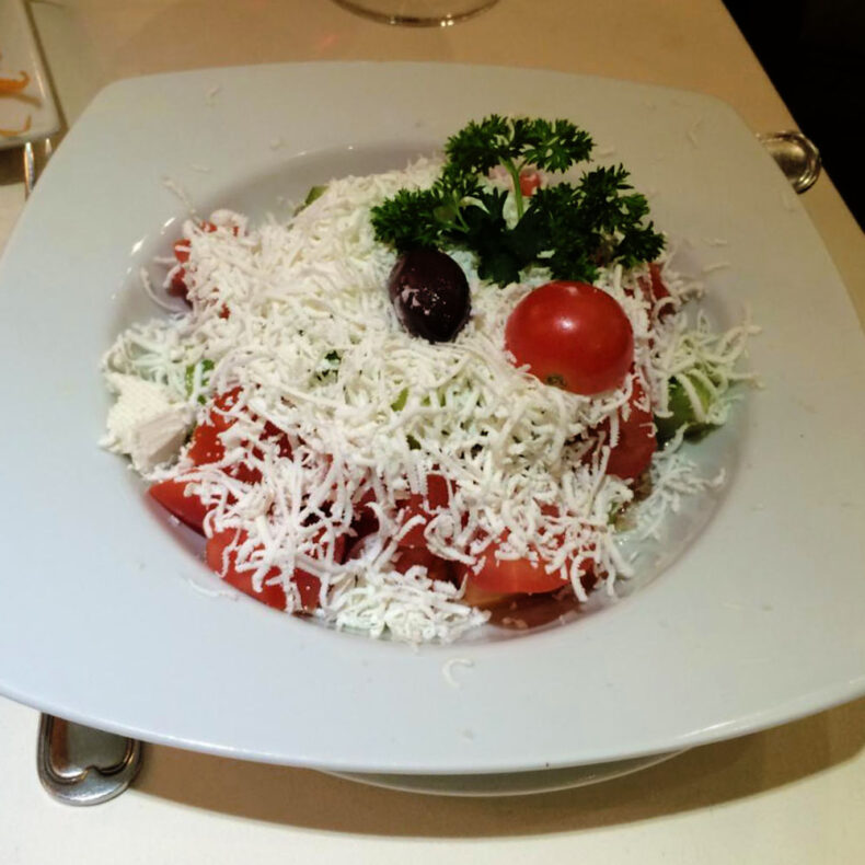 Shopska salad, a national salad in Skopje - a refreshing salad with tomatoes, cucumbers, and cheese