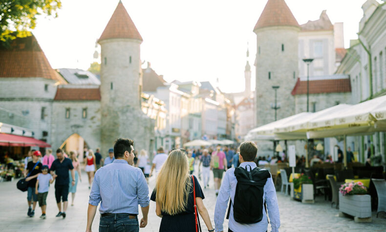Three people walking through the Tallinn Old Town streets