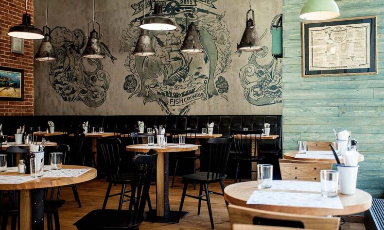 Restaurant Zivju Lete's interior are sea-inspired murals reminiscent of a ship’s cabin
