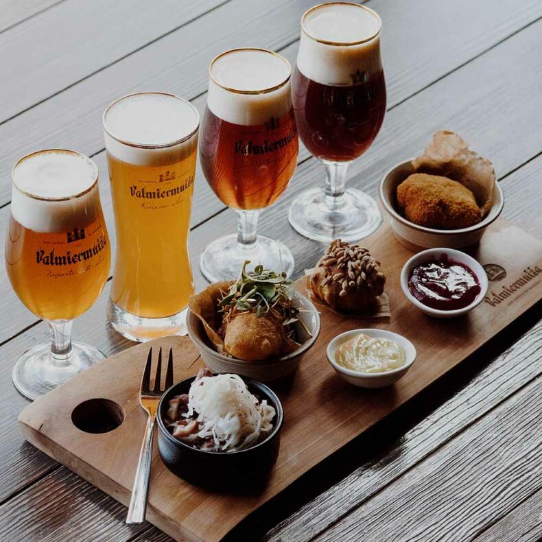 Visit Valmiermuiža Beer Embassy to taste locally crafted beers with snacks