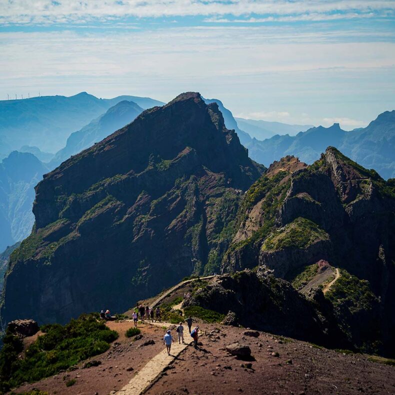 A group of people hiking to the Pico do Arieiro mountain