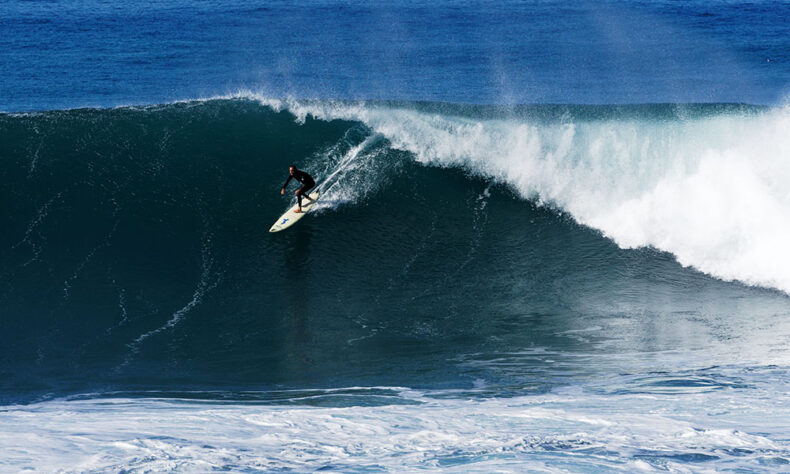 Man surfing at Jardim do Mar on the Atlantic island of Madeira