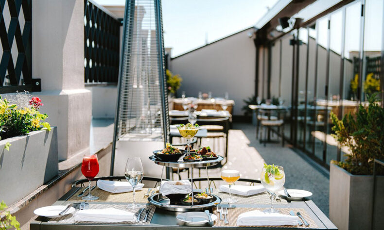 Served table at the rooftop restaurant and bar Stage 22 at the Grand Hotel Kempinski Riga