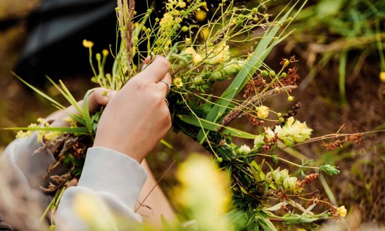 Celebrate Midsummer in Neringa gathering herbs with localcs and braiding wreaths