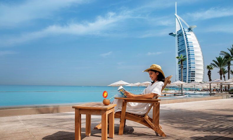 Jumeirah Public Beach with the iconic silhouette of the sail-shaped Burj Al Arab Jumeirah hotel in the background