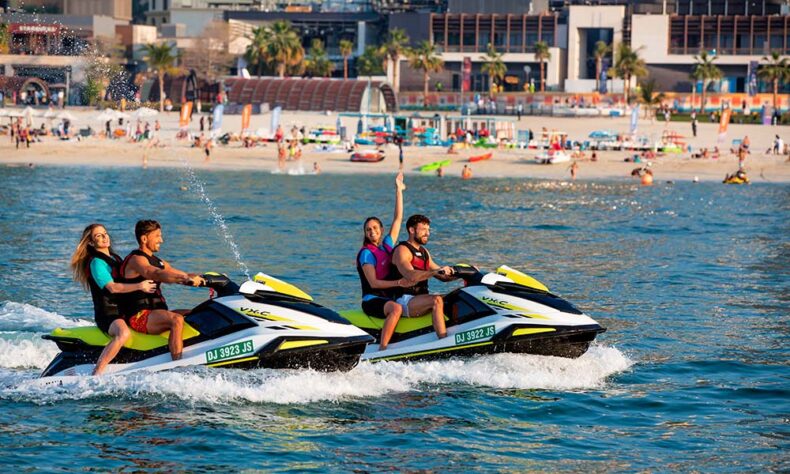 People have fun in water activities at the JBR beach in Dubai