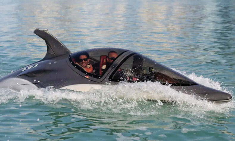 Plunges below the surface of the water in the shark-like Seabreacher submarine