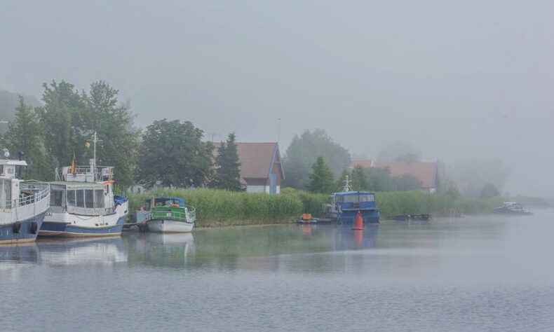 View of the homes and fishing boats from a part of the Baltic Hiking Trail - Nemunas Delta