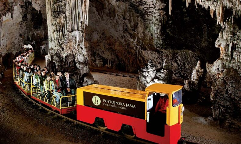 At Postojna Cave, you can ride through an ancient cave system in a tiny electric train