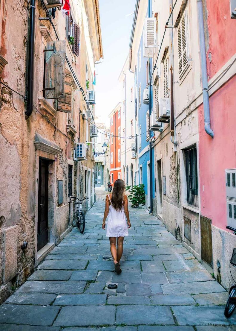 Woman walking the narrow streets in Piran