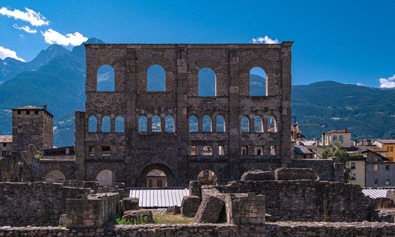 The Roman monument ruins at the Aosta Valley region capital with mountains in the background