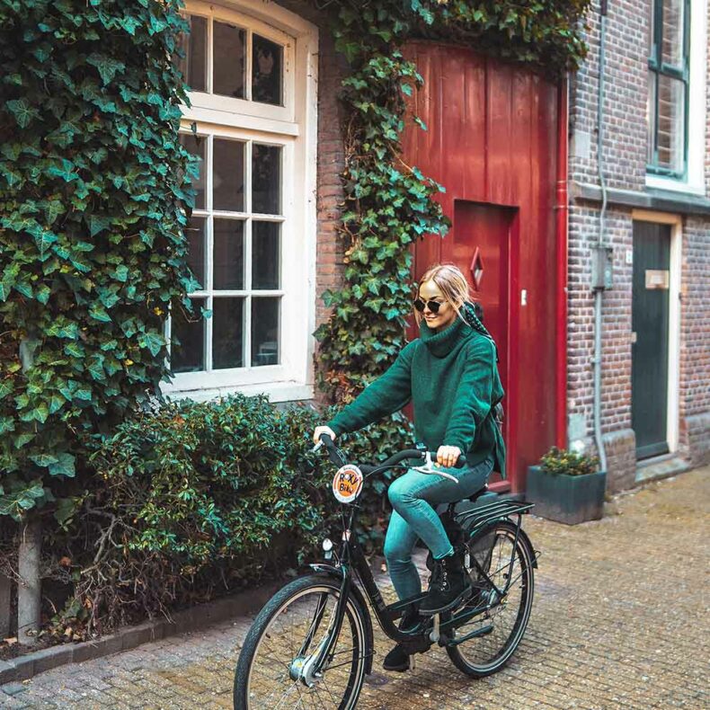 Woman riding a bike through Amsterdam's streets