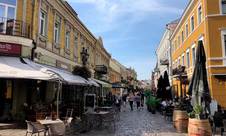 A view of Kaunas Old Town cobbled street with restaurants
