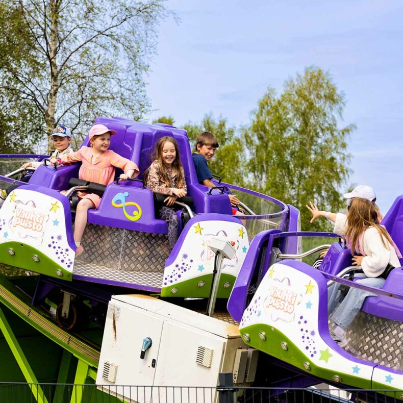 Kids enjoy a carousel at the Vauhtipuisto amusement park