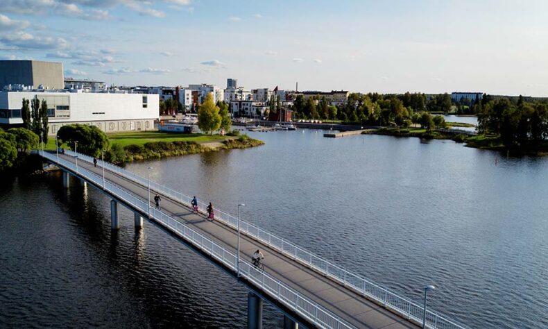 People cycling on the bridge in Oulu which is one of Europe’s most bike-friendly cities