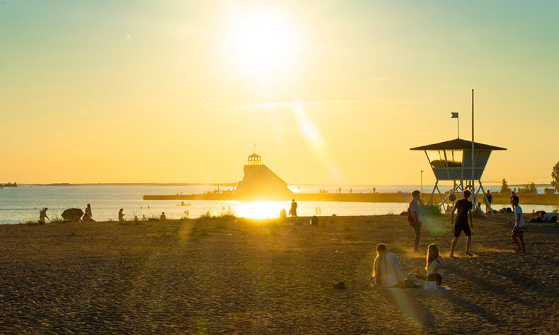 People enjoy a sunny evening at Nallikari Beach