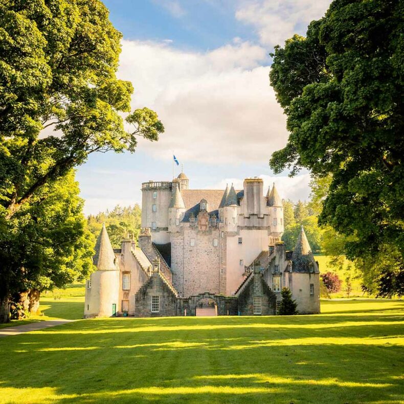 The historic stone exterior and round towers of Castle Fraser in Scotland