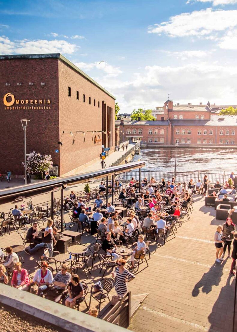 People enjoy summer and drinks on terrace in Tampere