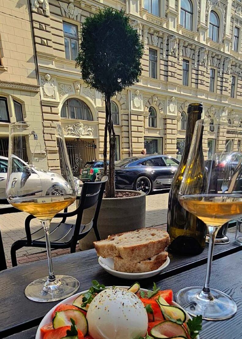 Wine and snacks at the Truffle Pig with a view on art nouveau building in Riga