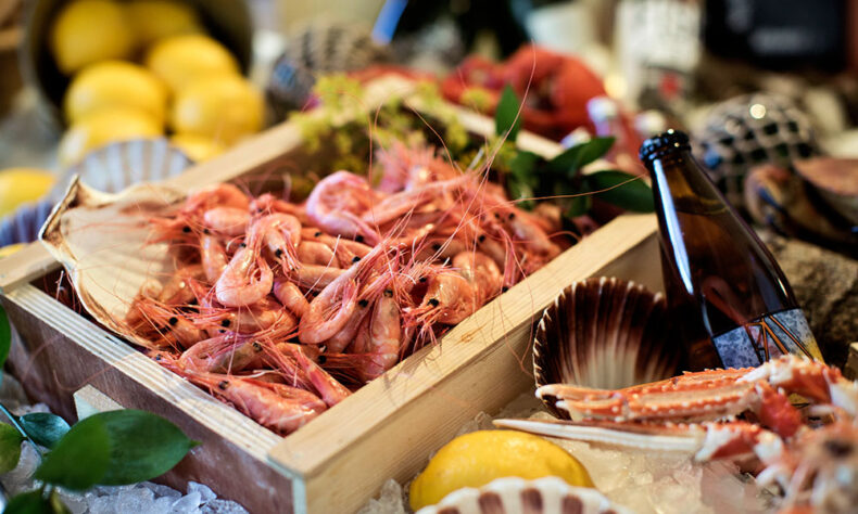 Freshly caught prawns on bed of ice at the fish market in Sweden
