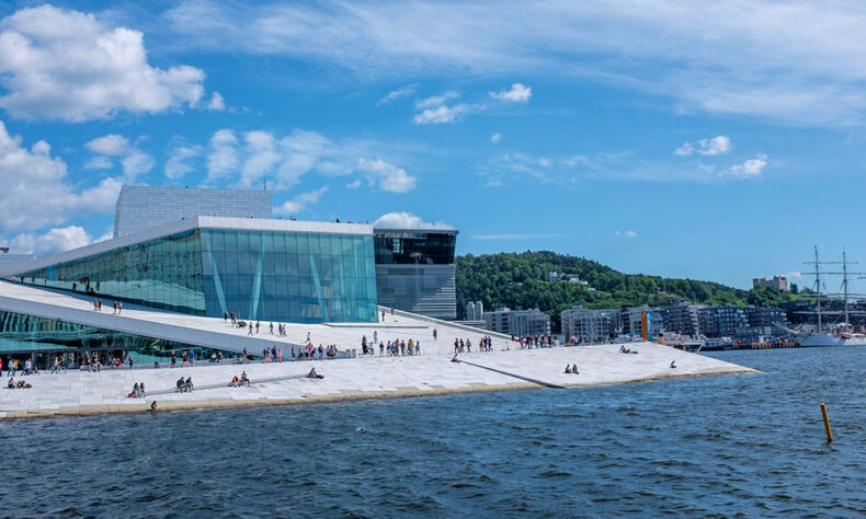 Oslo Opera house and people who are enjoying harbourside