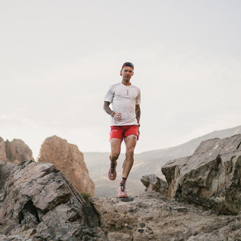 Gvido Kalnins running in a rugged terrain