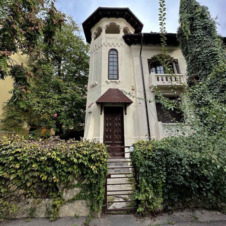 A historic villa in Bucharest's Cotroceni neighborhood featuring a corner tower, dark wood entryway, and ornate architectural details