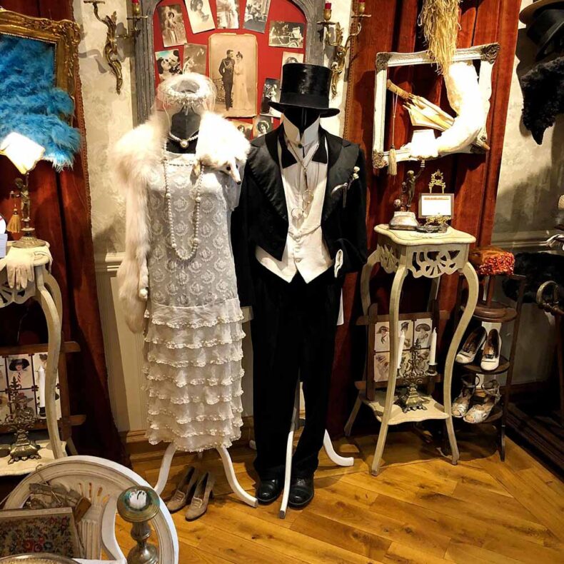 Part of the Little Paris Museum exponents - white women dress with fur and black man tuxedo