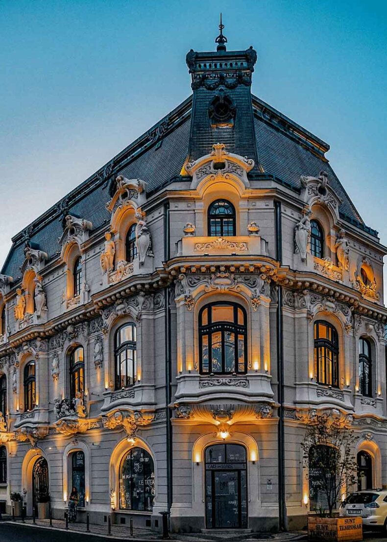 The exterior facade of the historic Casa Miţa Biciclista in Bucharest, showcasing its ornate French Baroque and Neo-Baroque architectural details