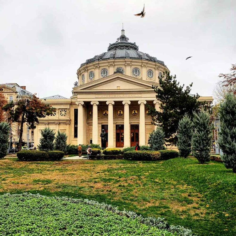 The Romanian Athenaeum is an iconic concert hall that features a majestic neoclassical columned portico and a 41-meter-high domed rotunda